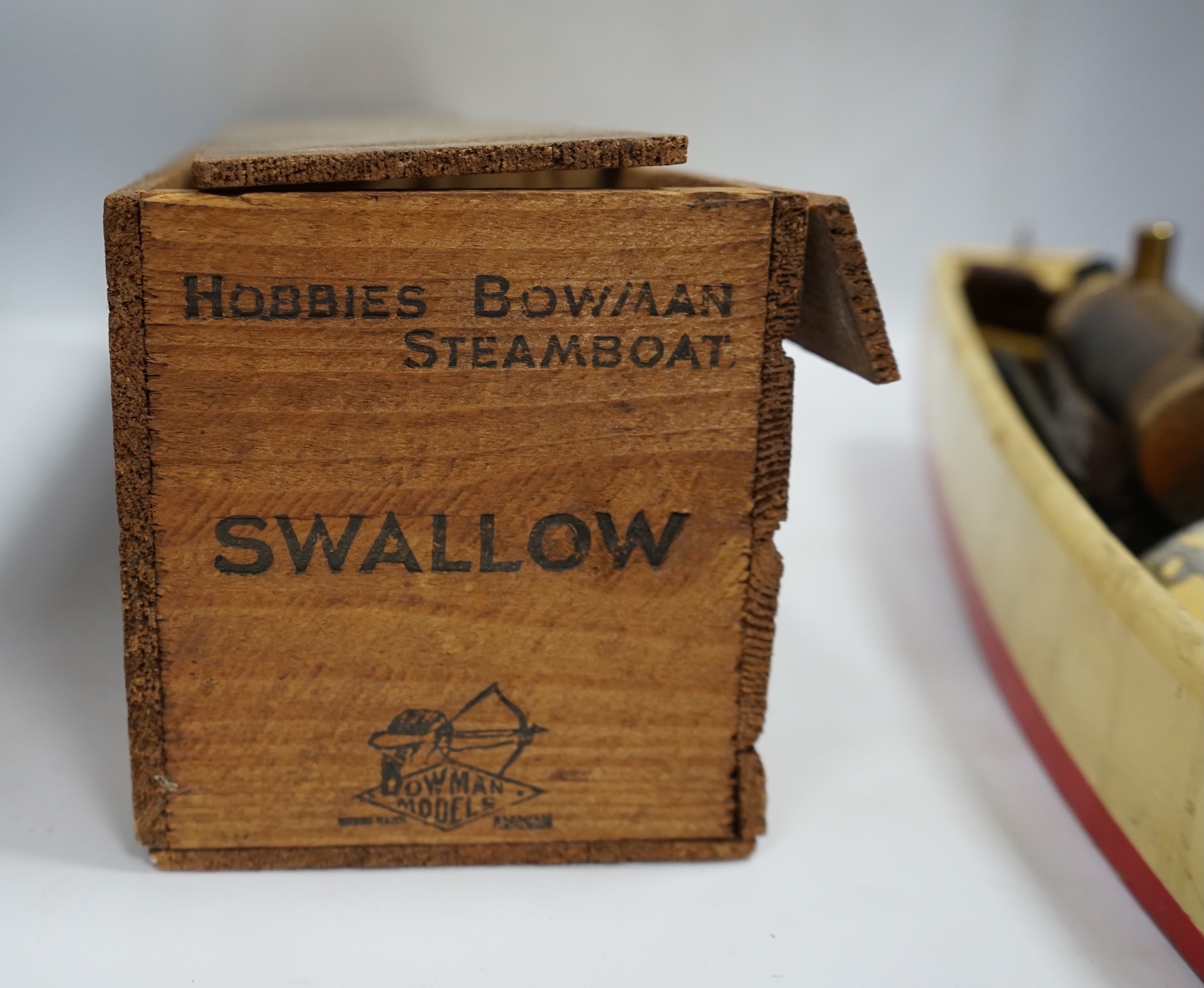 A 1930s wooden boxed Bowman Models live steam speedboat; ‘Swallow’, of wood and tinplate construction, hull 49cm long. Condition - fair.